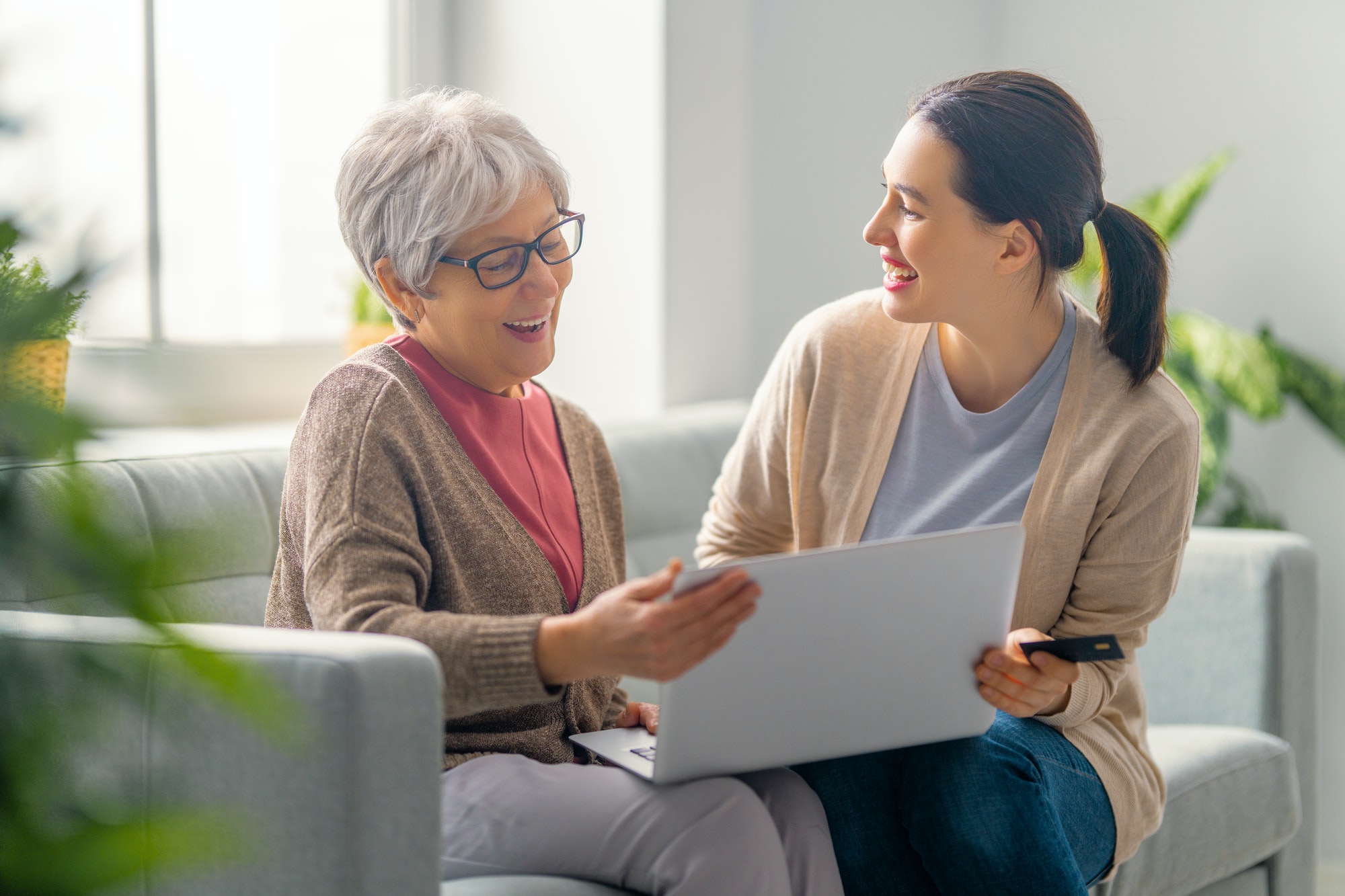 Young and senior women are using laptop